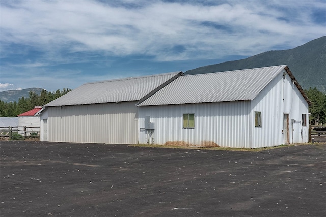 3333 Middle Rd, Columbia Falls, MT 59912 - view of property exterior featuring a mountain view, a pole building, an outdoor structure, and a metal roof