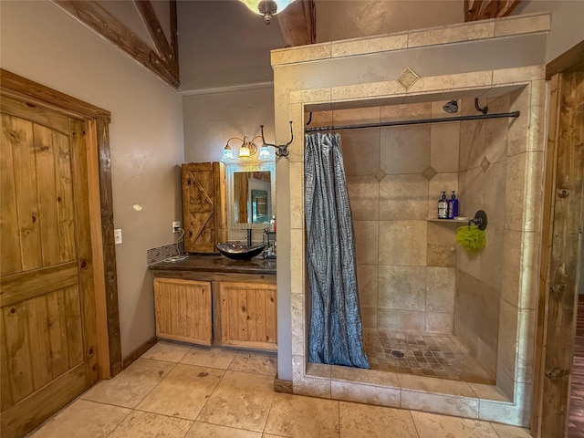23254 Dayton Creek Rd, Proctor, MT 59929 - bathroom featuring vanity, tiled shower, and tile patterned floors