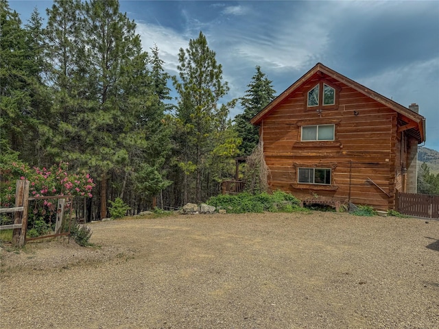 23254 Dayton Creek Rd, Proctor, MT 59929 - view of side of home with a chimney