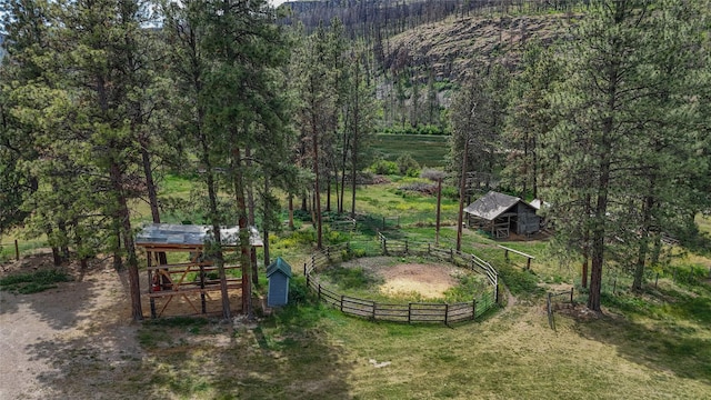 23254 Dayton Creek Rd, Proctor, MT 59929 - view of yard with an outdoor structure, an exterior structure, a wooded view, and a rural view