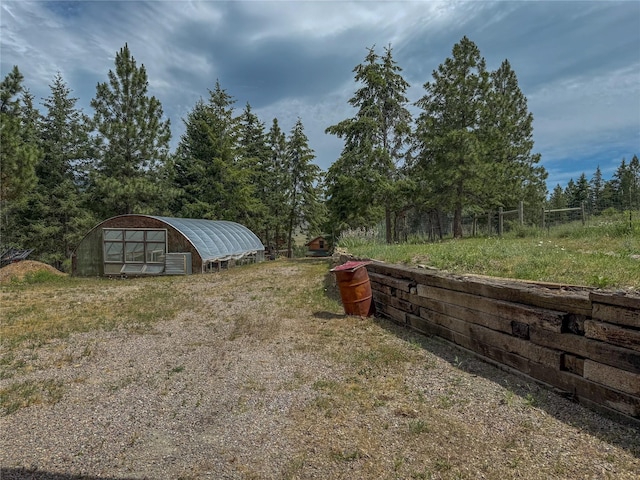 23254 Dayton Creek Rd, Proctor, MT 59929 - view of yard featuring an outbuilding and a greenhouse