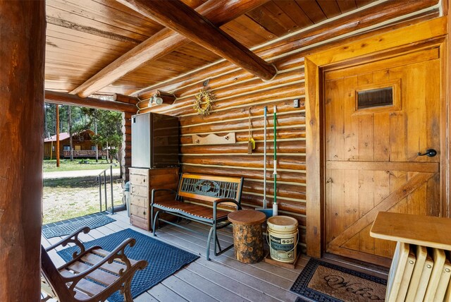 392 Leisure Ln, Sula, MT 59871 - mudroom with a wood ceiling with exposed beams, hardwood / wood-style flooring, and rustic walls