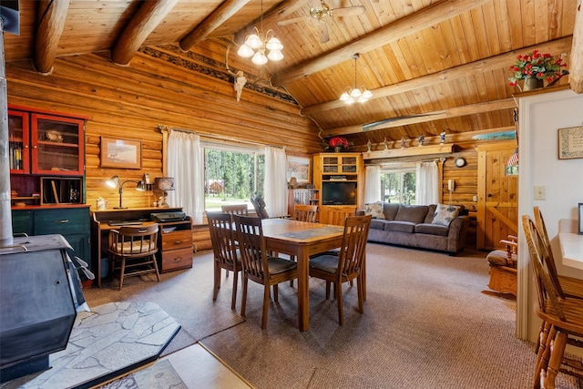 392 Leisure Ln, Sula, MT 59871 - dining area featuring a wood stove, a chandelier, wood ceiling, carpet flooring, and rustic walls