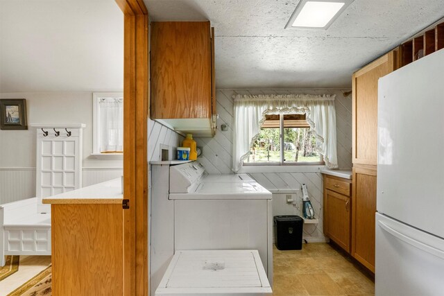 392 Leisure Ln, Sula, MT 59871 - washroom with cabinet space, separate washer and dryer, and wood walls