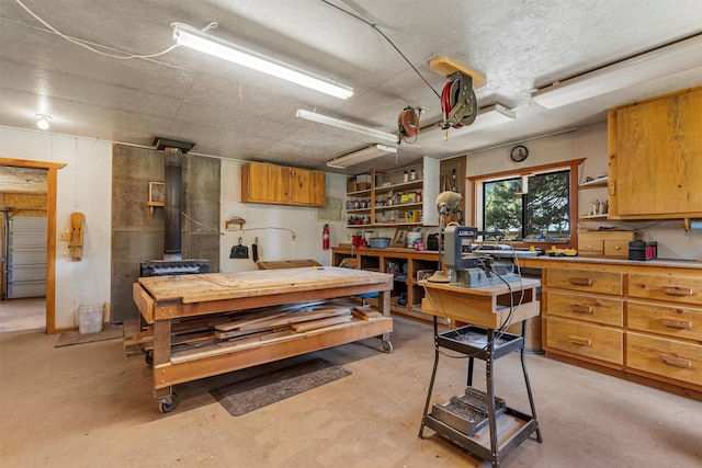 392 Leisure Ln, Sula, MT 59871 - garage with a workshop area and a wood stove