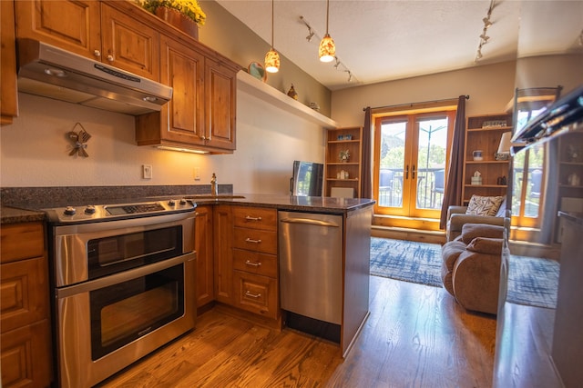 62 S Last Chance Gulch Gulch Unit 5, Helena, MT 59601 - kitchen with appliances with stainless steel finishes, under cabinet range hood, rail lighting, french doors, and brown cabinets