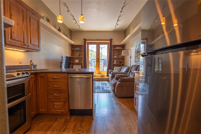 62 S Last Chance Gulch Gulch Unit 5, Helena, MT 59601 - kitchen with stainless steel appliances, french doors, rail lighting, brown cabinetry, and a textured ceiling