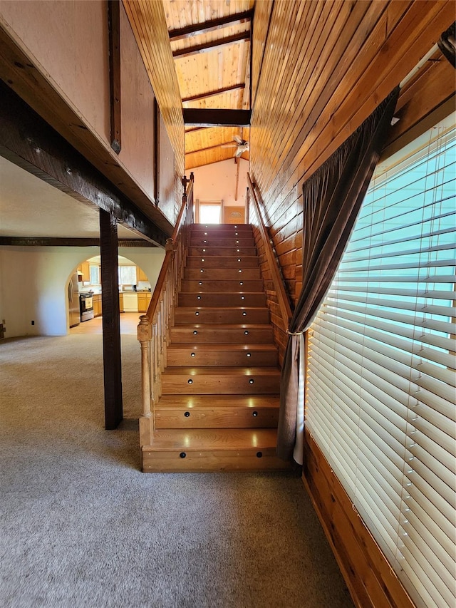 74 Cedar Crk, Libby, MT 59923 - stairway featuring carpet floors, arched walkways, wooden ceiling, and vaulted ceiling