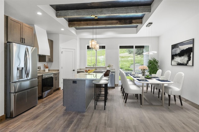 237 W Nicklaus Ave, Kalispell, MT 59901 - kitchen featuring appliances with stainless steel finishes, light countertops, a raised ceiling, wood finished floors, and recessed lighting