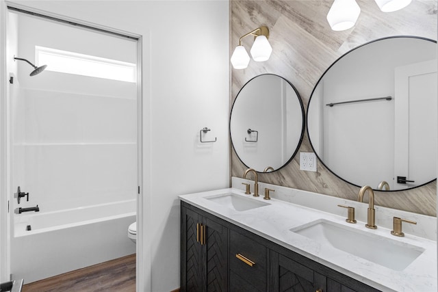 237 W Nicklaus Ave, Kalispell, MT 59901 - bathroom featuring double vanity, shower / tub combination, and wood finished floors