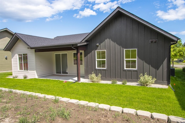 237 W Nicklaus Ave, Kalispell, MT 59901 - rear view of house featuring board and batten siding, a patio area, a yard, and roof with shingles