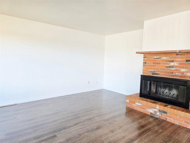 1401 Park Garden Rd, Great Falls, MT 59404 - unfurnished living room featuring wood finished floors and a brick fireplace