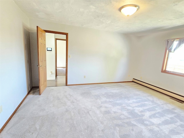 1401 Park Garden Rd, Great Falls, MT 59404 - spare room with baseboard heating, light colored carpet, and a textured ceiling