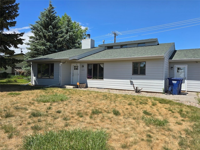 1401 Park Garden Rd, Great Falls, MT 59404 - rear view of house featuring a lawn, a chimney, and a shingled roof