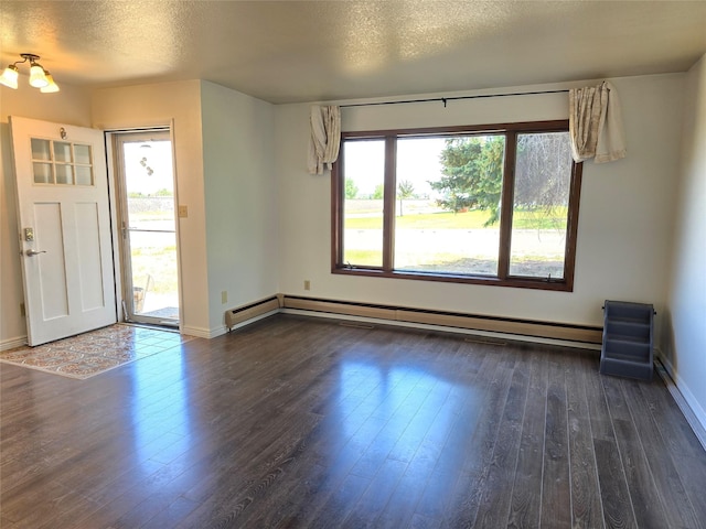 1401 Park Garden Rd, Great Falls, MT 59404 - foyer entrance with baseboard heating, dark wood-style floors, and a textured ceiling