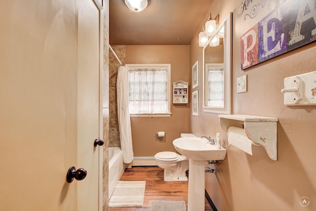 216 W Riggs St, East Helena, MT 59635 - full bath with wood finished floors, a baseboard radiator, and shower / tub combo