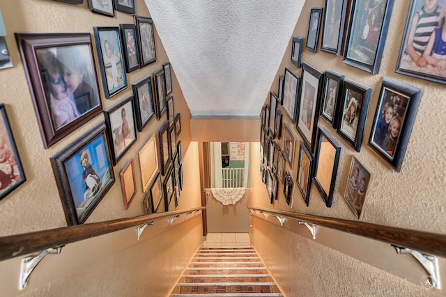 216 W Riggs St, East Helena, MT 59635 - staircase featuring a textured ceiling and a textured wall