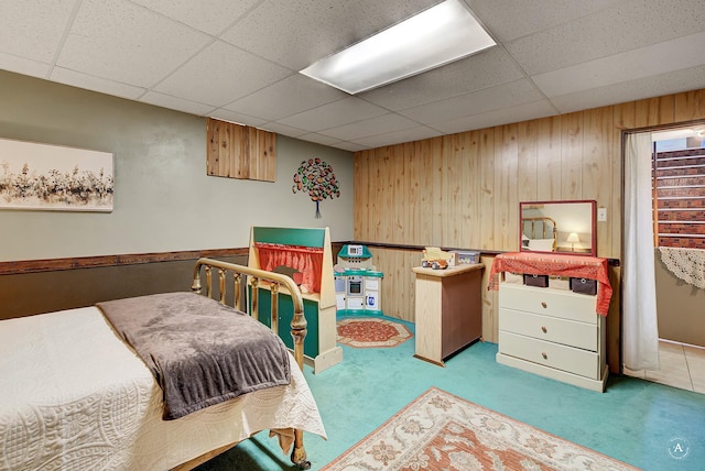 216 W Riggs St, East Helena, MT 59635 - carpeted bedroom featuring wooden walls and a paneled ceiling