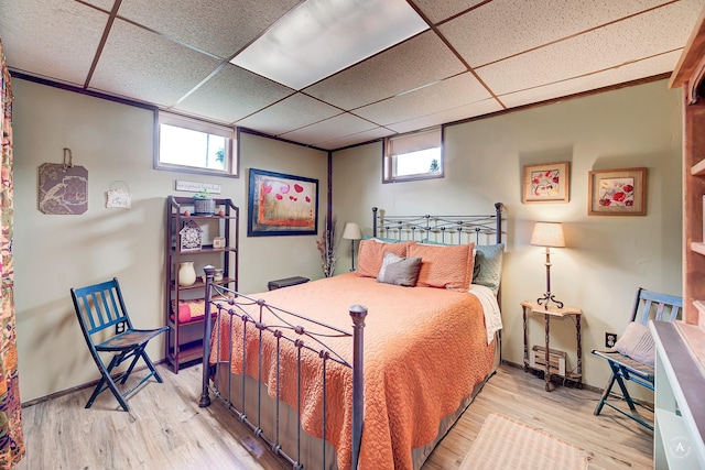 216 W Riggs St, East Helena, MT 59635 - bedroom featuring multiple windows, a paneled ceiling, and wood finished floors
