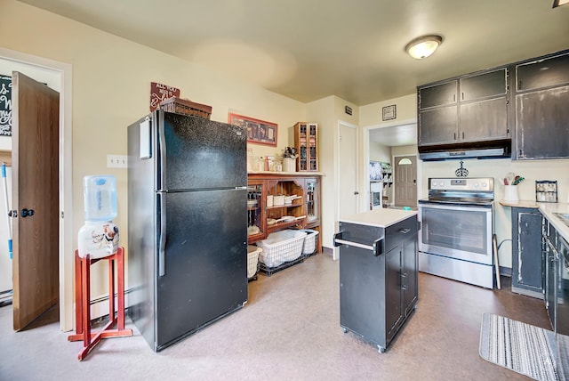 216 W Riggs St, East Helena, MT 59635 - kitchen featuring stainless steel range with electric stovetop, freestanding refrigerator, light countertops, and a center island