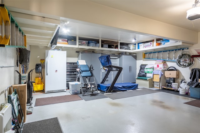467 Ridgeway Dr, Lolo, MT 59847 - garage featuring freestanding refrigerator and a garage door opener