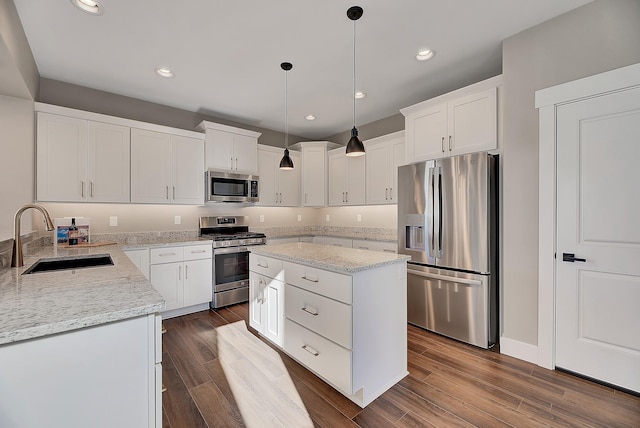 2933 Travis Ave, Helena, MT 59601 - kitchen with stainless steel appliances, light stone countertops, recessed lighting, a kitchen island, and dark wood finished floors