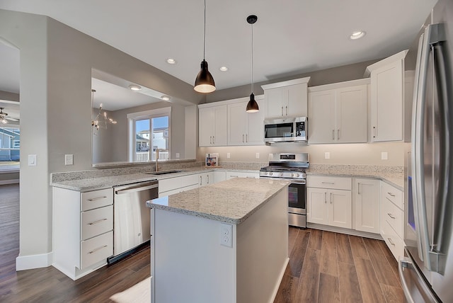 2933 Travis Ave, Helena, MT 59601 - kitchen featuring stainless steel appliances, dark wood-style floors, a kitchen island, recessed lighting, and white cabinetry