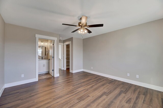 2933 Travis Ave, Helena, MT 59601 - unfurnished bedroom with dark wood-style flooring, a walk in closet, a closet, ceiling fan, and ensuite bathroom