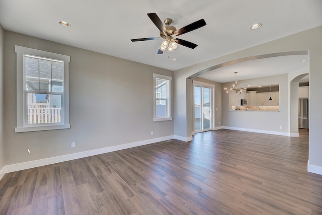2933 Travis Ave, Helena, MT 59601 - unfurnished living room featuring plenty of natural light, arched walkways, a chandelier, and recessed lighting