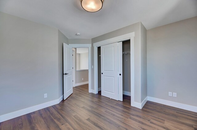 2933 Travis Ave, Helena, MT 59601 - unfurnished bedroom with dark wood-style flooring and a closet
