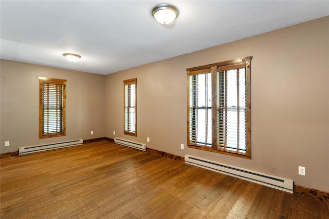 28578 Wapiti Ln, Bigfork, MT 59911 - spare room with baseboard heating and wood finished floors