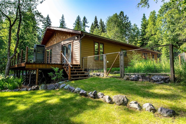 28578 Wapiti Ln, Bigfork, MT 59911 - rear view of house with a wooden deck and a gate