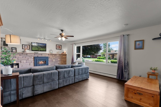 3906 Bellecrest Dr, Missoula, MT 59801 - living room featuring baseboard heating, ceiling fan, a textured ceiling, dark wood-style floors, and track lighting
