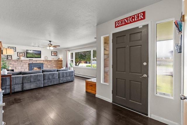 3906 Bellecrest Dr, Missoula, MT 59801 - entryway with a baseboard radiator, a ceiling fan, a textured ceiling, a glass covered fireplace, and dark wood finished floors