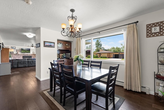 3906 Bellecrest Dr, Missoula, MT 59801 - dining space featuring a chandelier, a textured ceiling, dark wood-type flooring, and baseboard heating