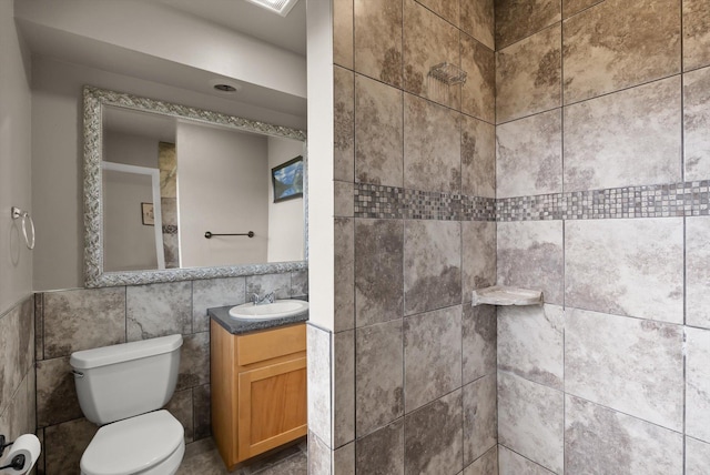 3906 Bellecrest Dr, Missoula, MT 59801 - full bathroom featuring vanity, tiled shower, and tile walls