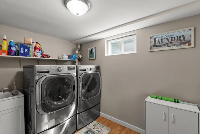 3906 Bellecrest Dr, Missoula, MT 59801 - laundry area with washer and clothes dryer, light wood finished floors, and cabinet space