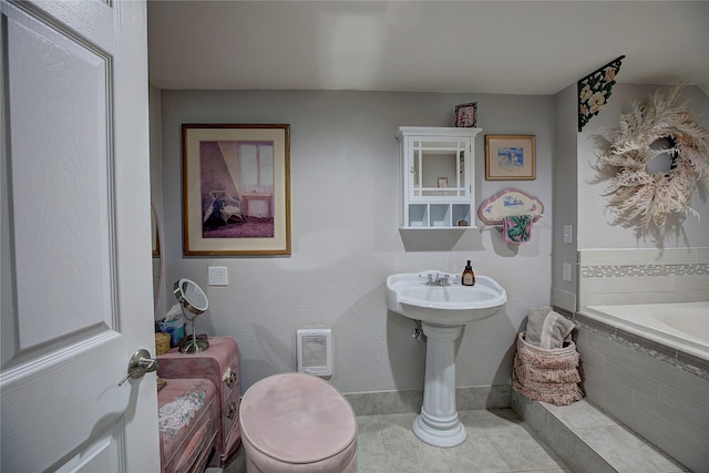 36500 Haack Rd, Polson, MT 59860 - full bathroom with a relaxing tiled tub and tile patterned flooring