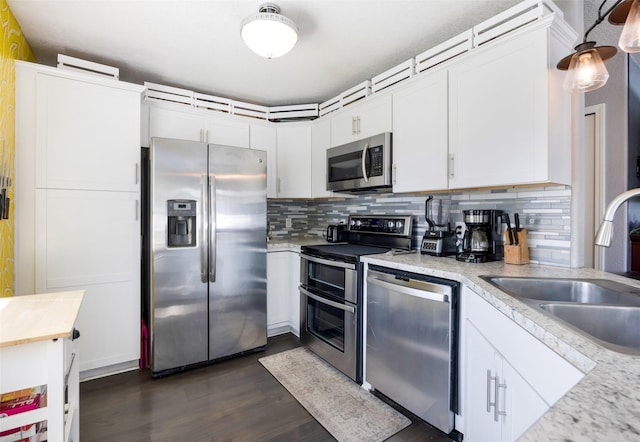 2702 Fleet St, Missoula, MT 59808 - kitchen featuring stainless steel appliances, tasteful backsplash, white cabinetry, and dark wood-style flooring