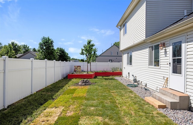 2702 Fleet St, Missoula, MT 59808 - fenced backyard with entry steps and a vegetable garden