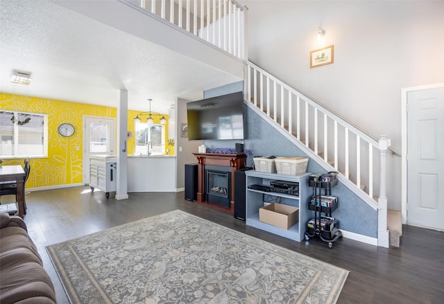 2702 Fleet St, Missoula, MT 59808 - living room with wood finished floors, stairs, wallpapered walls, and a fireplace