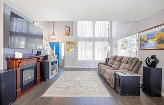 2702 Fleet St, Missoula, MT 59808 - living area with stairs, dark wood finished floors, and a glass covered fireplace