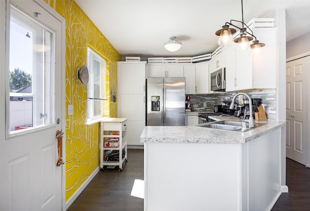 2702 Fleet St, Missoula, MT 59808 - kitchen with appliances with stainless steel finishes, dark wood-type flooring, light countertops, and decorative backsplash