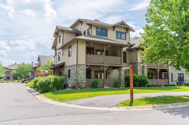 6008 St Moritz Dr Unit K, Whitefish, MT 59937 - view of front facade featuring stone siding, a front yard, and a balcony
