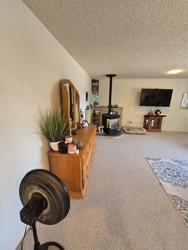 761 32nd Ave NE, Great Falls, MT 59404 - carpeted living room featuring a wood stove and a textured ceiling