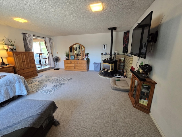 761 32nd Ave NE, Great Falls, MT 59404 - bedroom with a wood stove, carpet, and a textured ceiling