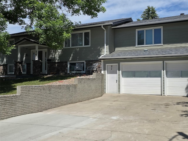 761 32nd Ave NE, Great Falls, MT 59404 - view of front facade featuring concrete driveway and a garage