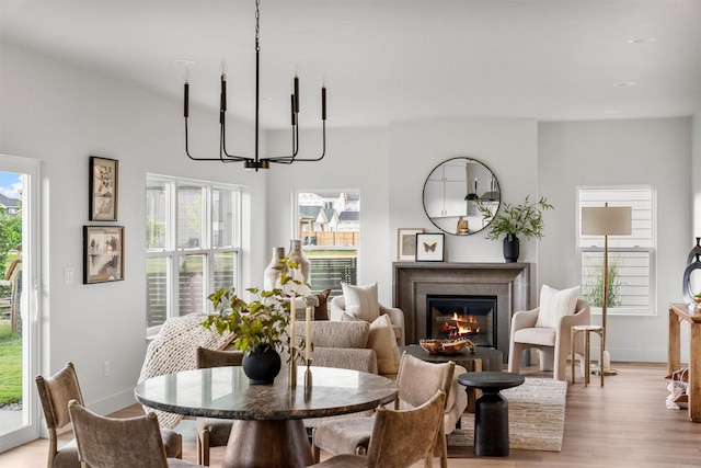 5465 Remington Dr, Missoula, MT 59808 - dining area with light wood finished floors and a warm lit fireplace