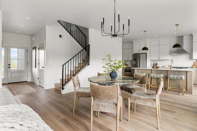 5465 Remington Dr, Missoula, MT 59808 - dining room with light wood-style flooring, a chandelier, stairway, and recessed lighting