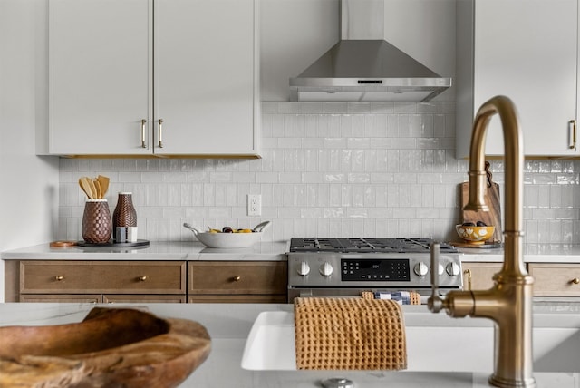 5465 Remington Dr, Missoula, MT 59808 - kitchen featuring wall chimney exhaust hood, stainless steel range with gas cooktop, and decorative backsplash